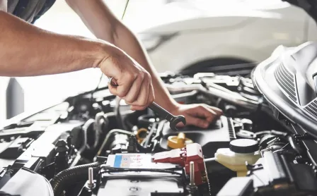muscular-car-service-worker-repairing-vehicle-e1726094836719 (1)